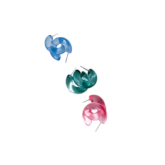 Three colorful earrings on a white surface
